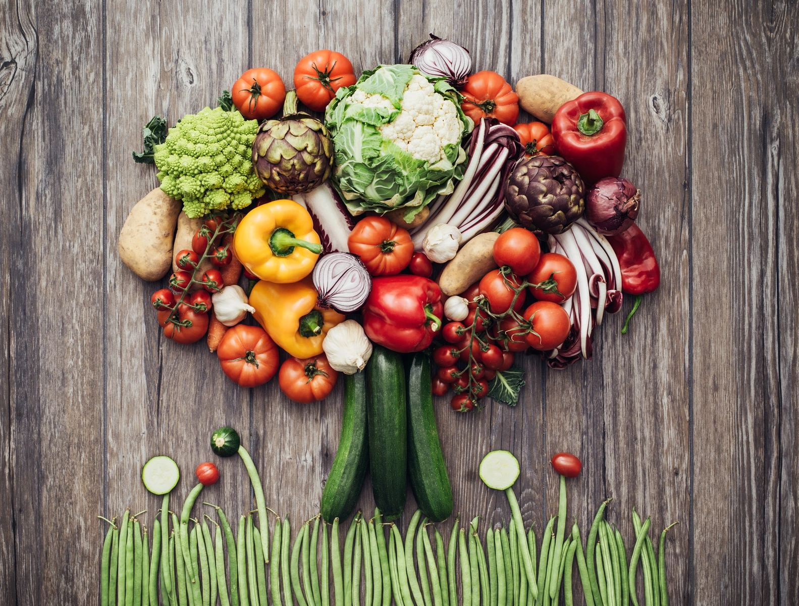 Co jeść, żeby schudnąć? Jaka jest najlepsza dieta na odchudzanie? Warzywa ułożone w kształt drzewa na drewnianym stole.